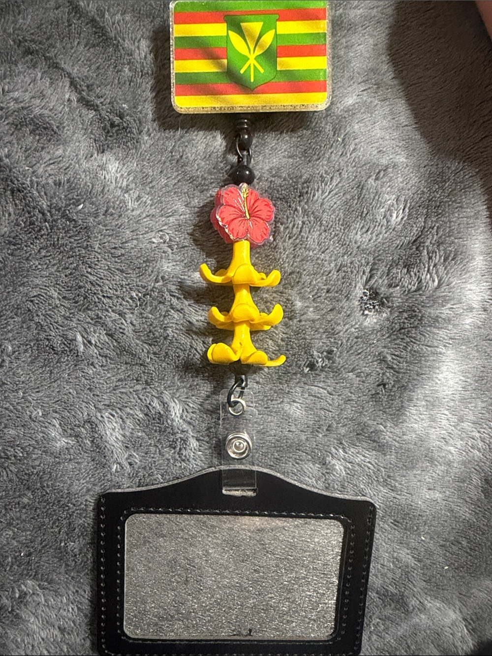 Kanaka Maoli Badge Reel with Yellow Puakenikeni Flowers and Hibiscus Charm